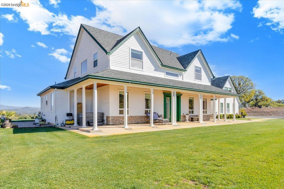 14814 Twist Road Jamestown, CA 95327 - Photo 5 of 60 rear view of property with a large porch, a yard, and a shingled roof