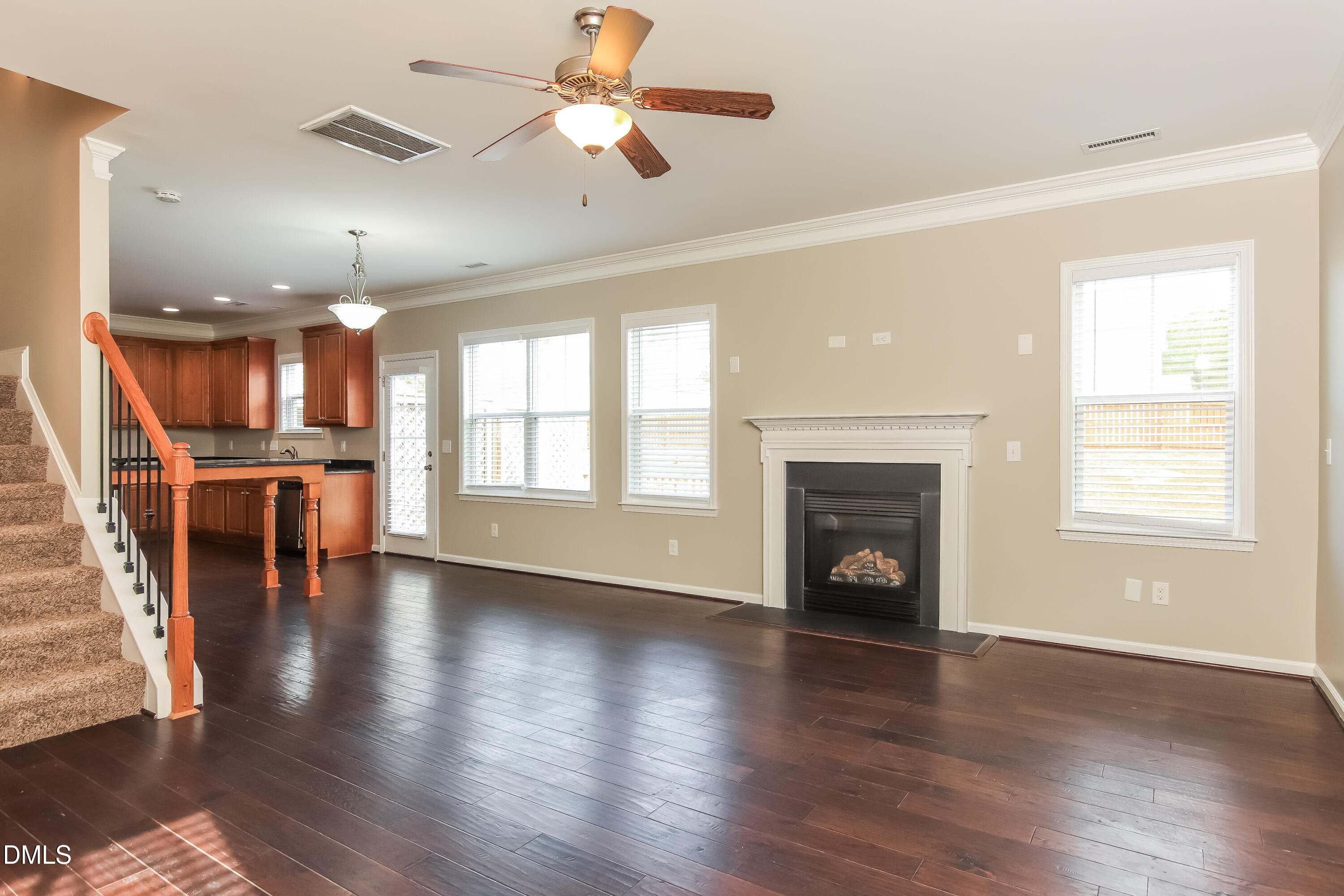 1237 Barnford Mill Road Wake Forest, NC 27587 - Photo 2 of 17 an empty room with wooden floor fireplace and windows