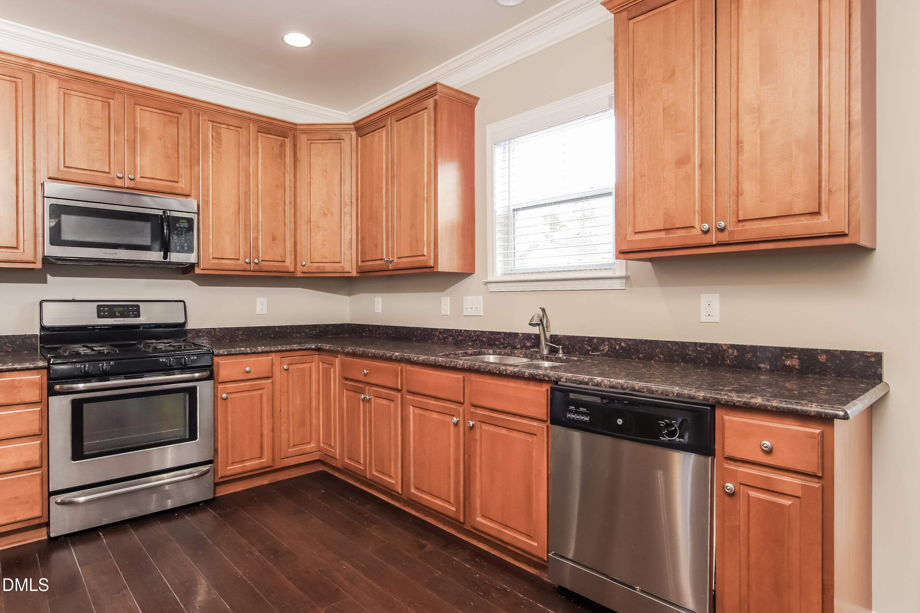 1237 Barnford Mill Road Wake Forest, NC 27587 - Photo 7 of 17 a kitchen with granite countertop wooden cabinets and stainless steel appliances