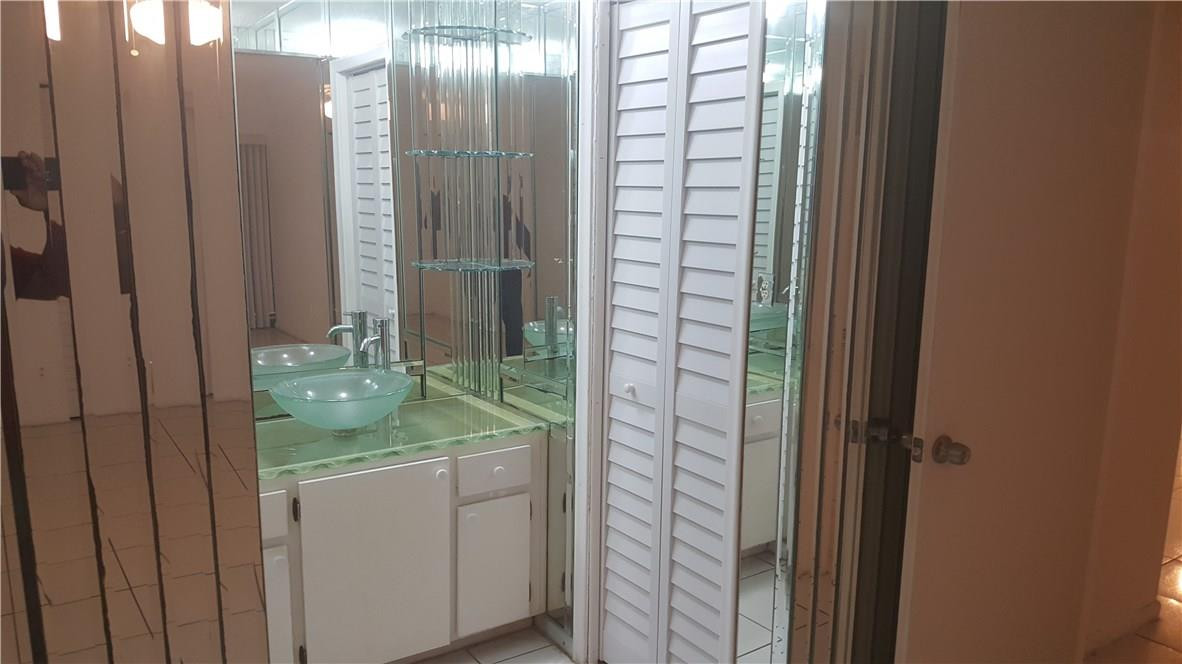 3591 Inverrary Drive, Unit 406 Lauderhill, FL 33319 - Photo 11 of 12 a bathroom with a granite countertop sink and a mirror