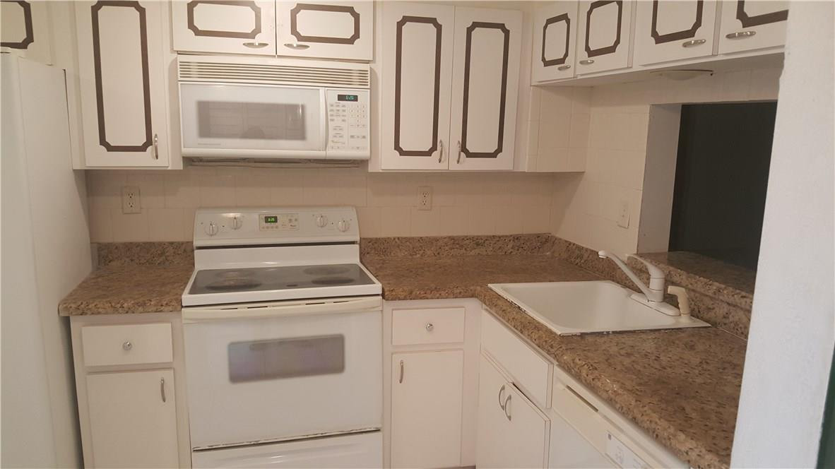 3591 Inverrary Drive, Unit 406 Lauderhill, FL 33319 - Photo 3 of 12 a view of a kitchen with cabinets and stainless steel appliances
