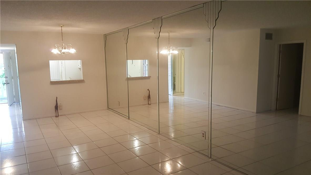 3591 Inverrary Drive, Unit 406 Lauderhill, FL 33319 - Photo 4 of 12 a view of an empty room with window and chandelier fan