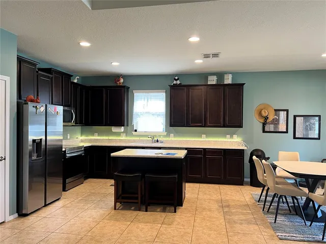 a kitchen with a sink and wooden cabinets