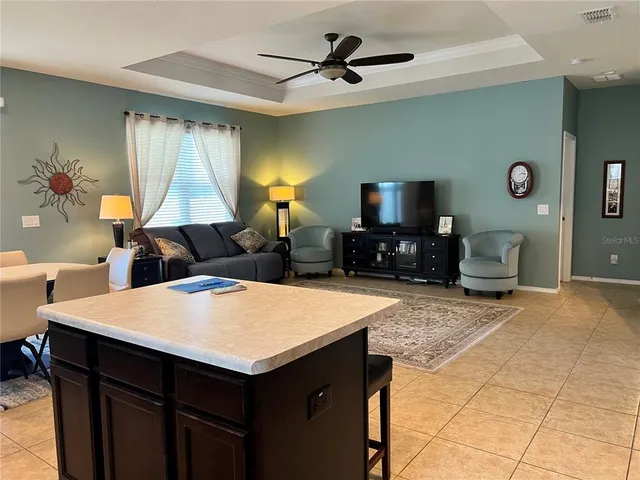 a kitchen with a table chairs and a refrigerator