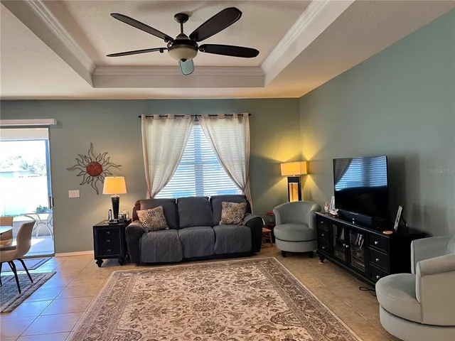 a living room with furniture a lamp and a flat screen tv