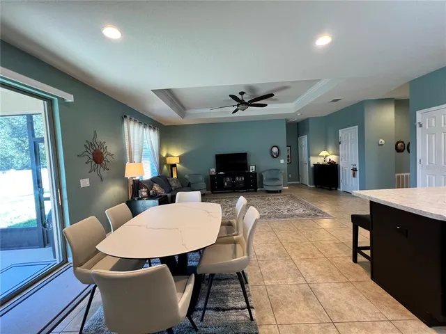 a living room with furniture a flat screen tv and a large window