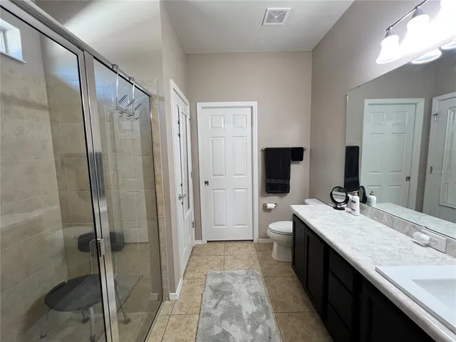 a bathroom with a double vanity sink mirror and shower