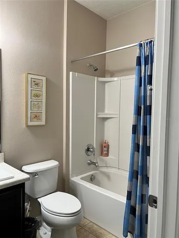 a white toilet sitting next to a bathroom sink
