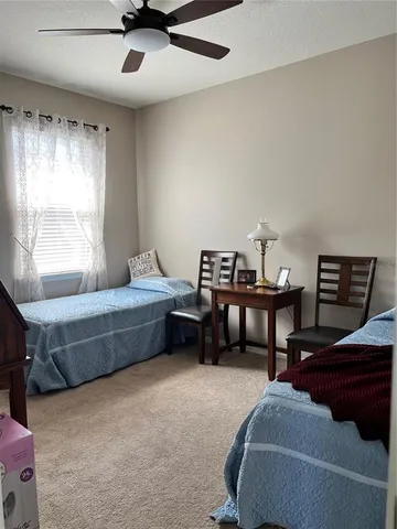 a bedroom with furniture and a window