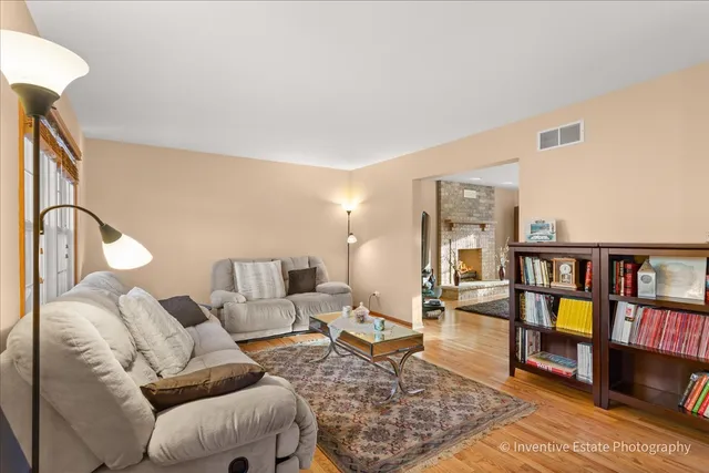 a living room with furniture and a book shelf