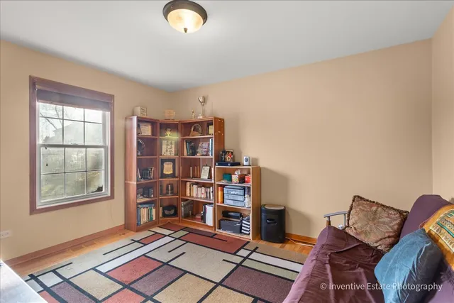 a living room with furniture and book shelf
