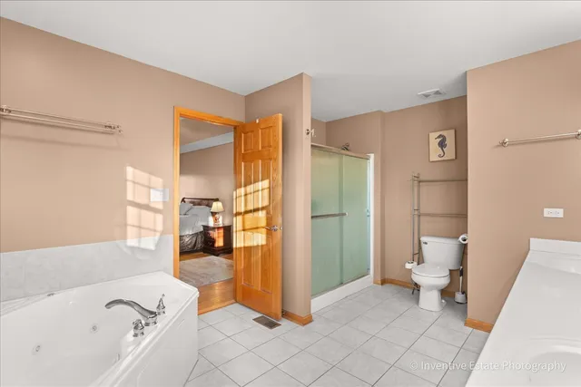 a bathroom with a tub toilet and a shower