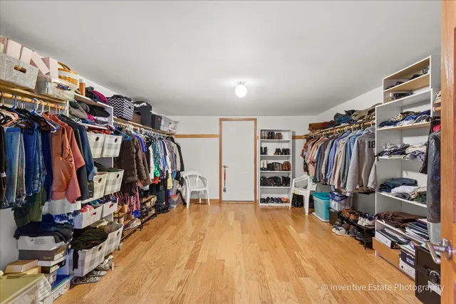 a view of walk in closet with clothes