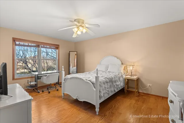 a spacious bedroom with a bed and glass table