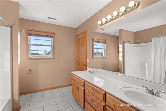 a bathroom with a sink vanity and a mirror