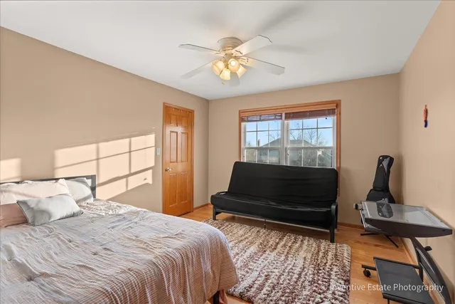 a bedroom with a bed a rug and dresser