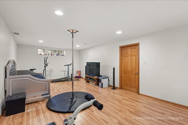 a room with table chairs and a flat screen tv