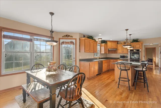 a dining room with furniture and wooden floor