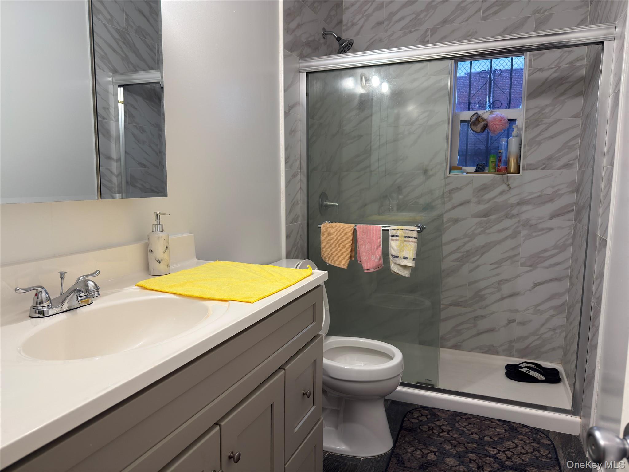 55-16 69th Street Queens, NY 11378 - Photo 10 of 28 a bathroom with a sink and a mirror