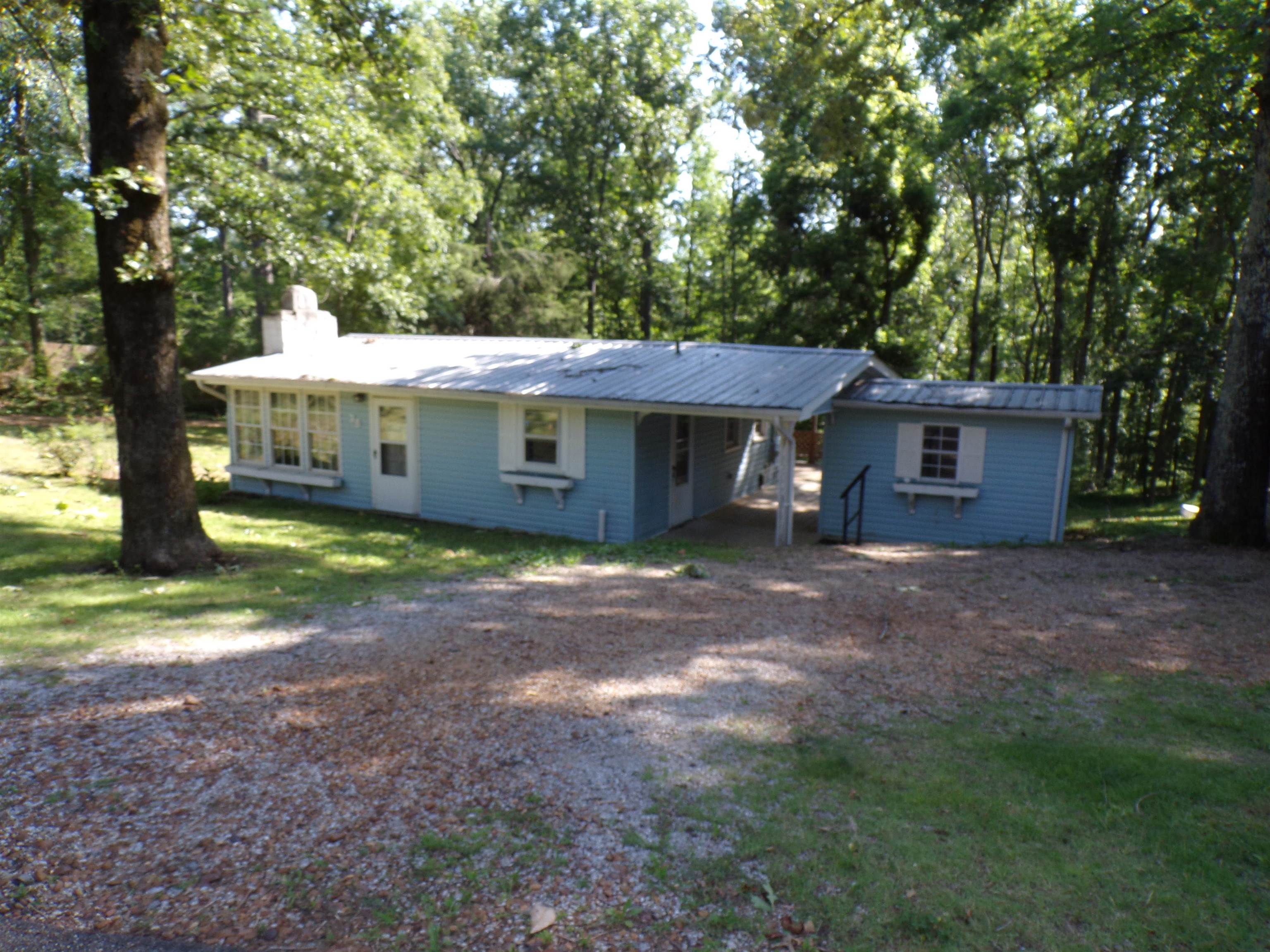 Light blue exterior with white trim and a metal roof