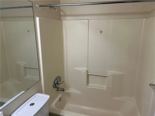a bathroom with a tub and a shower