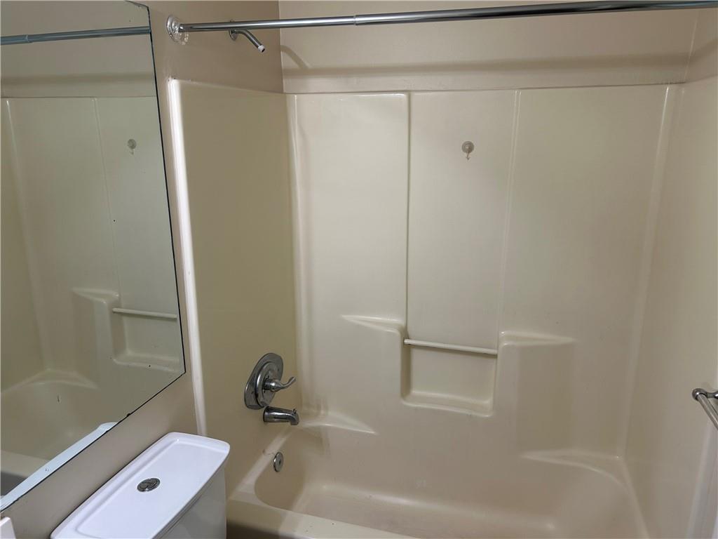 5323 Scarbrough Round Stone Mountain, GA 30088 - Photo 11 of 13 a bathroom with a tub and a shower