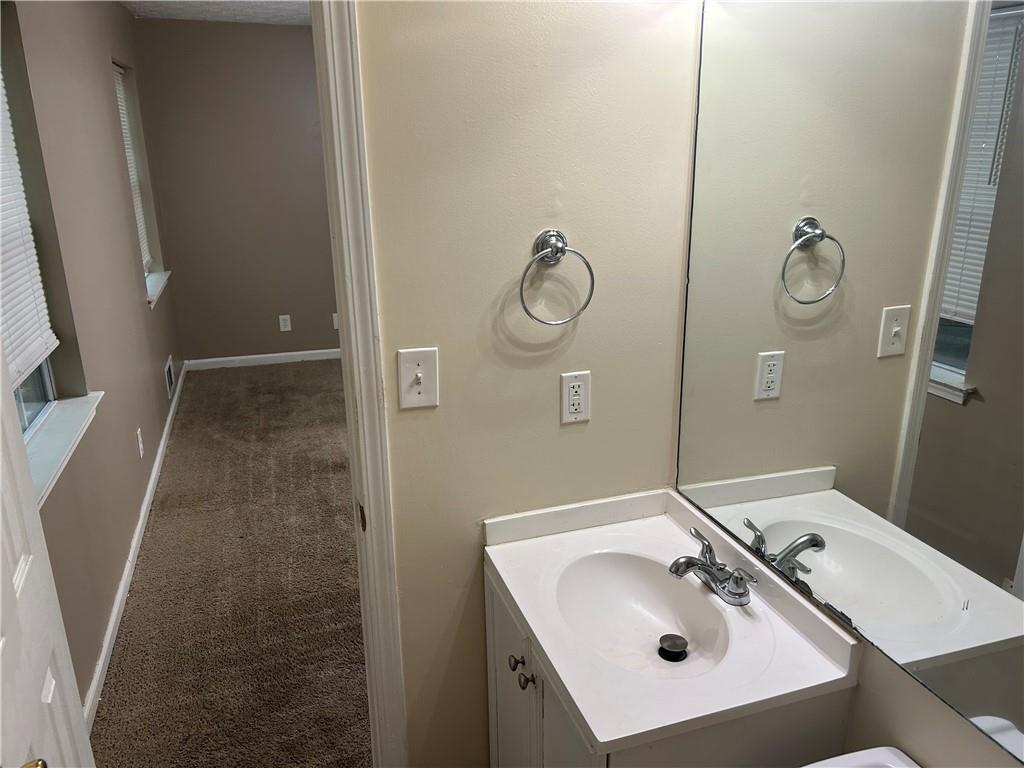 5323 Scarbrough Round Stone Mountain, GA 30088 - Photo 12 of 13 a bathroom with a sink and mirror