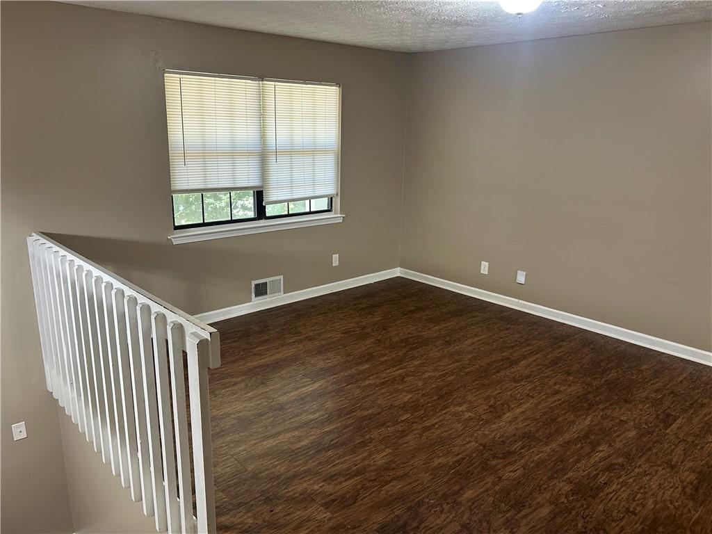 5323 Scarbrough Round Stone Mountain, GA 30088 - Photo 2 of 13 an empty room with wooden floor and windows