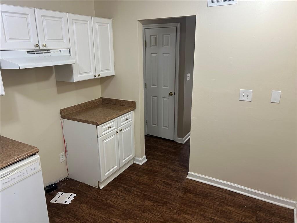 5323 Scarbrough Round Stone Mountain, GA 30088 - Photo 5 of 13 a kitchen with granite countertop white cabinets and white appliances