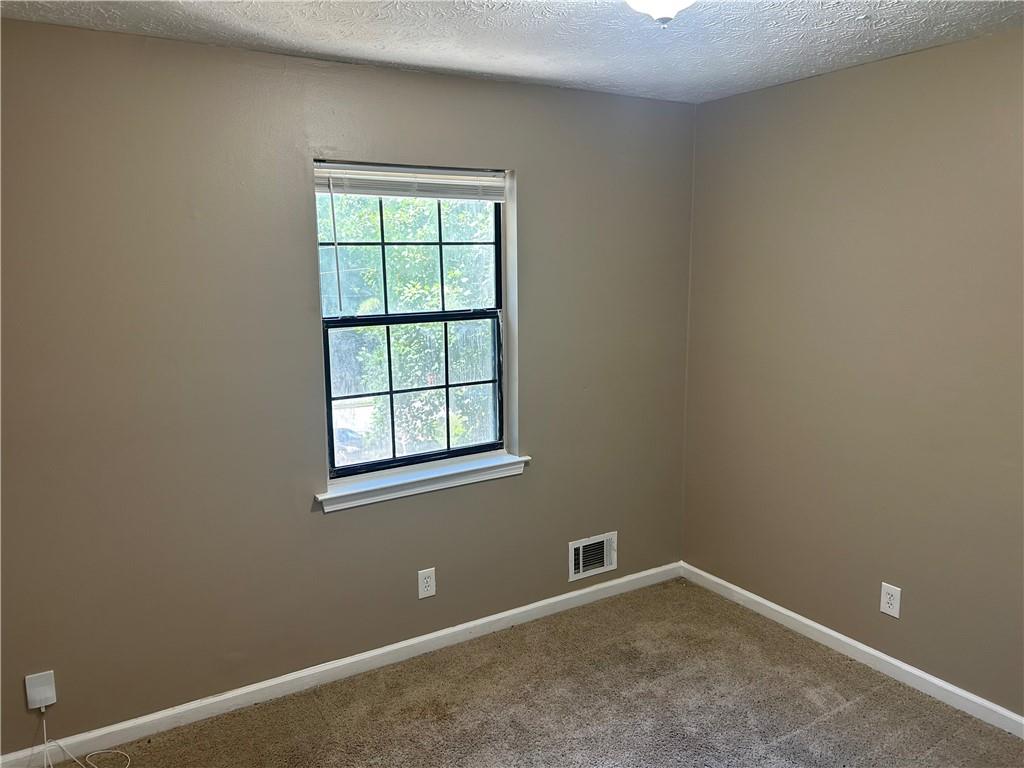 5323 Scarbrough Round Stone Mountain, GA 30088 - Photo 8 of 13 an empty room with a window