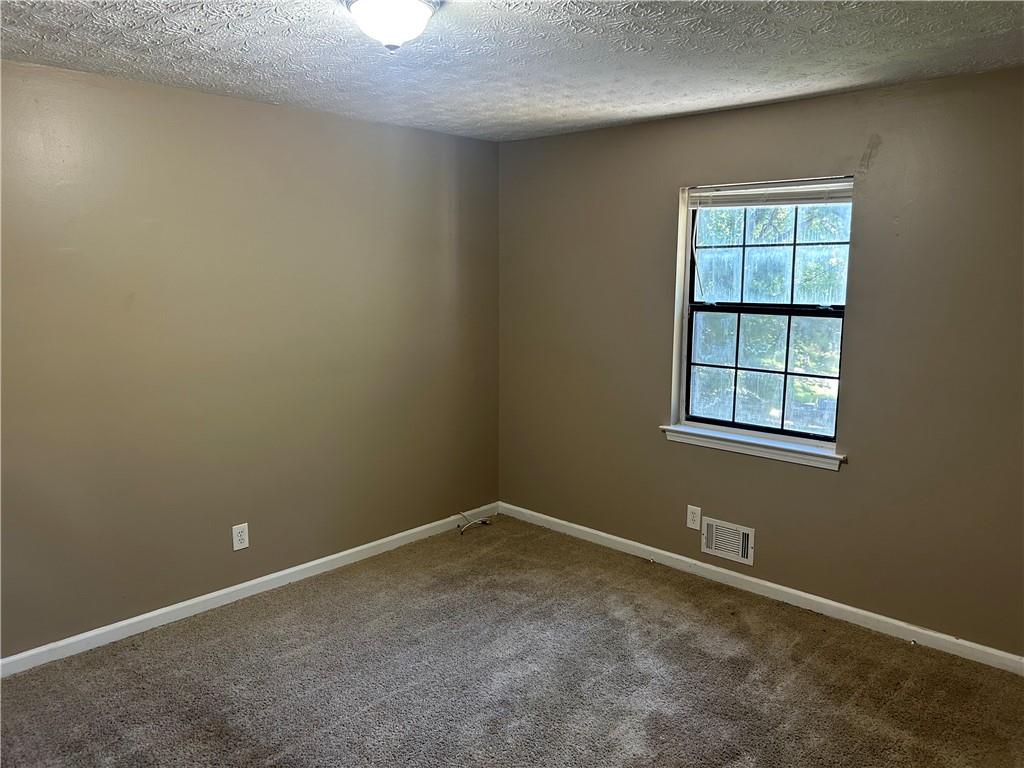 5323 Scarbrough Round Stone Mountain, GA 30088 - Photo 9 of 13 an empty room with windows