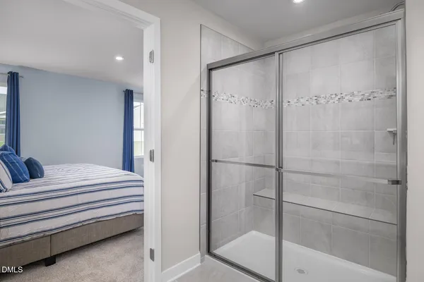 a spacious bathroom with a double vanity sink toilet and a mirror
