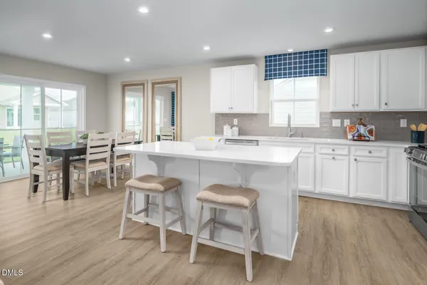 a kitchen with stainless steel appliances a stove refrigerator sink and cabinets