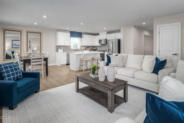 a living room with kitchen island furniture and a kitchen view