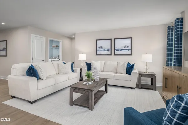 a living room with furniture and kitchen view