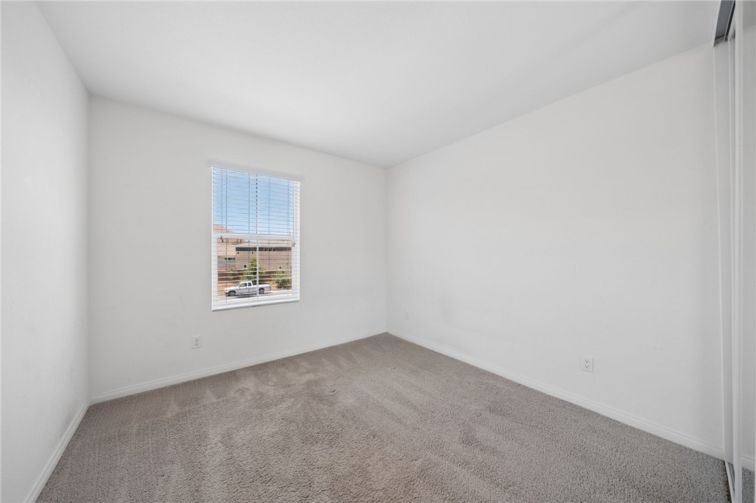 20130 Curaco Court Riverside, CA 92507 - Photo 31 of 43 Carpeted secondary bedroom with a front-facing window.