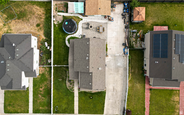 1443 West 250 North Springville, UT 84663 - Photo 8 of 23 Aerial view of the property featuring a light-colored roof, a concrete driveway, and a paved patio area