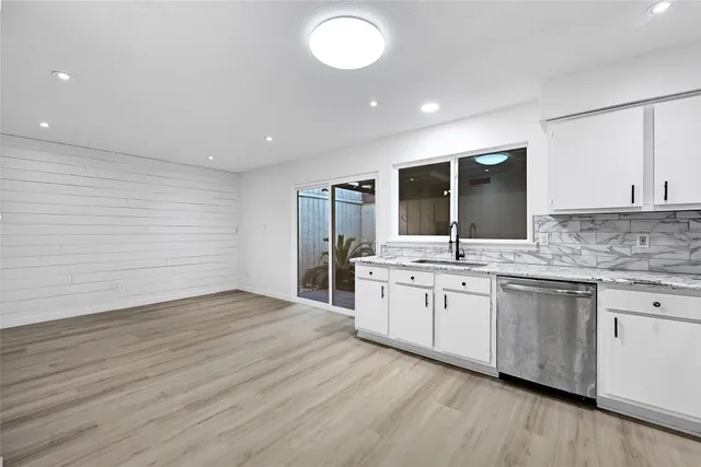 a kitchen with sink and cabinets