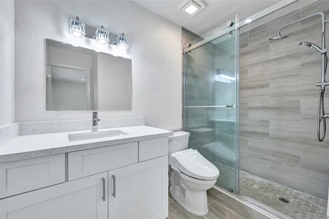 a bathroom with a sink toilet and shower