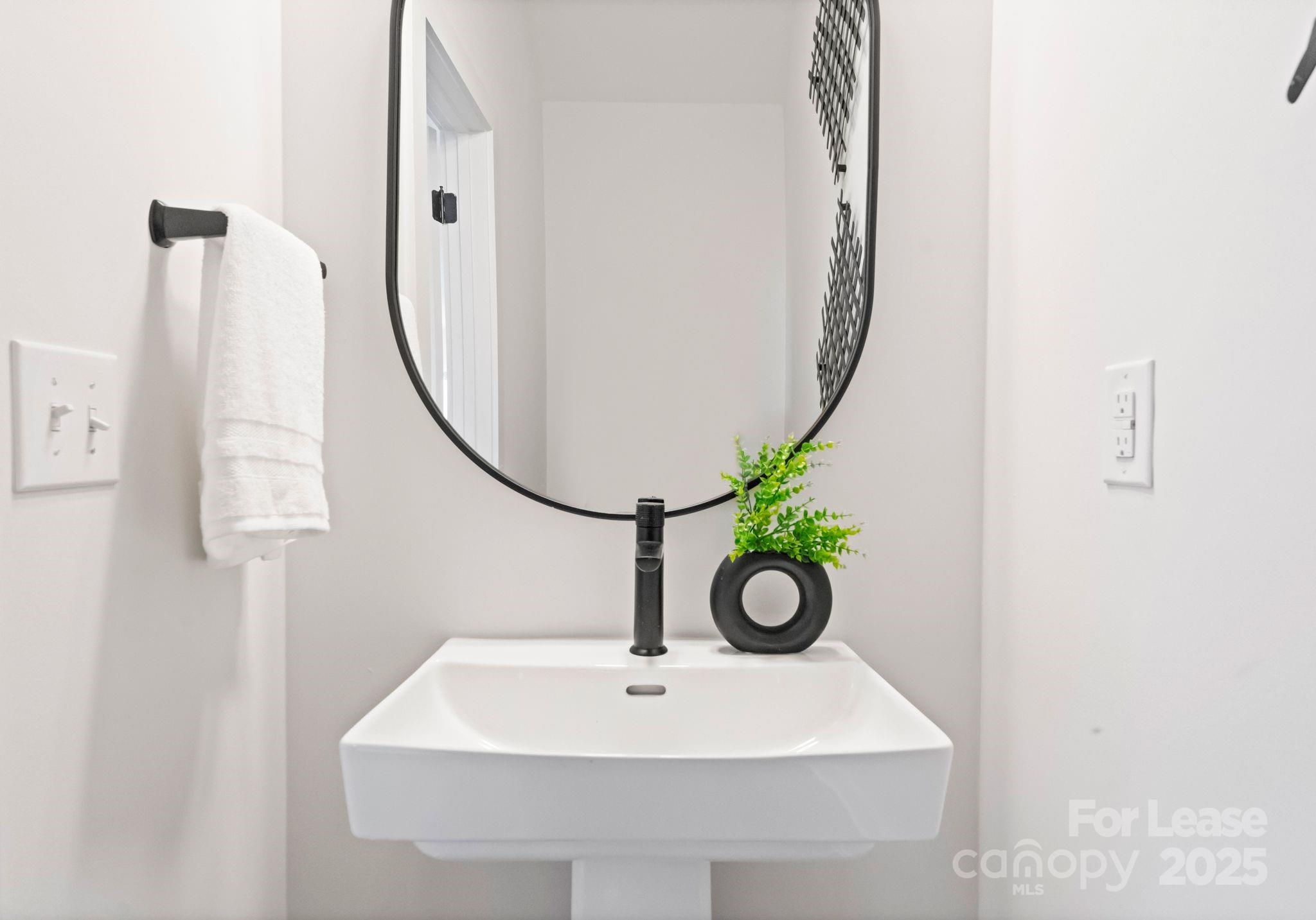 2413 Pruitt Street Charlotte, NC 28208 - Photo 11 of 35 a bathroom with a sink and a mirror