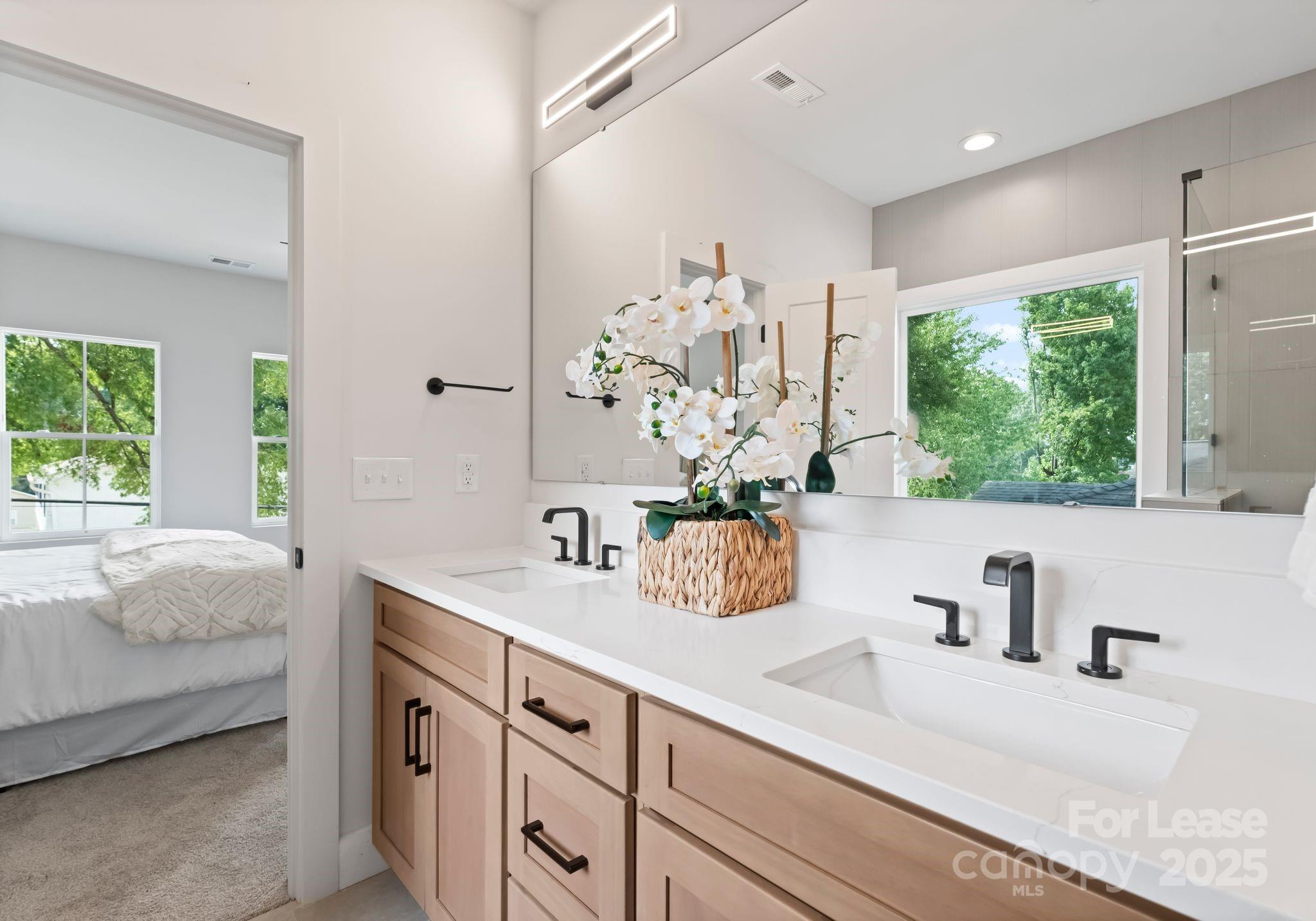 2413 Pruitt Street Charlotte, NC 28208 - Photo 17 of 35 a bathroom with a sink a mirror and a shower