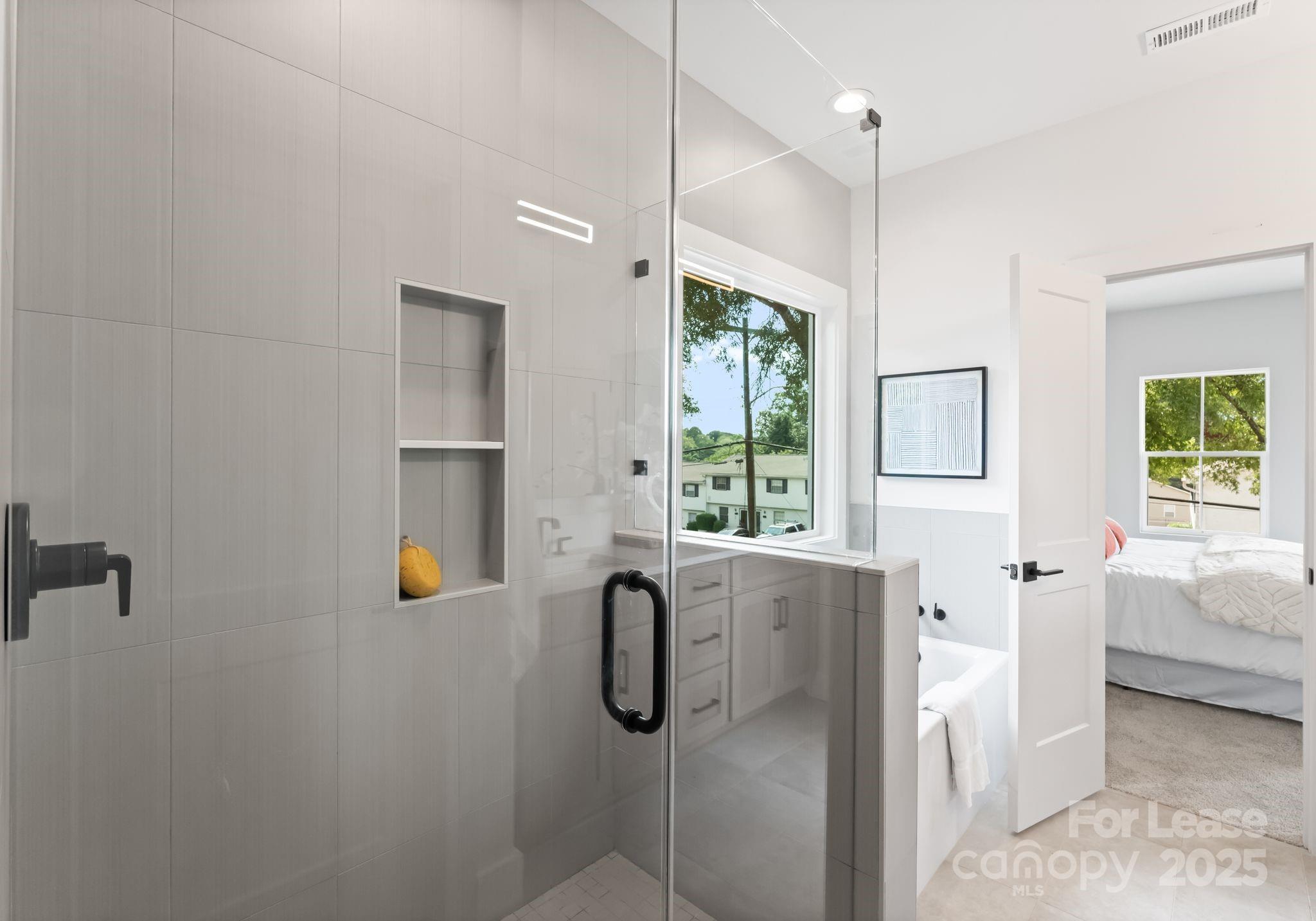 2413 Pruitt Street Charlotte, NC 28208 - Photo 18 of 35 a bathroom with a tub sink and mirror