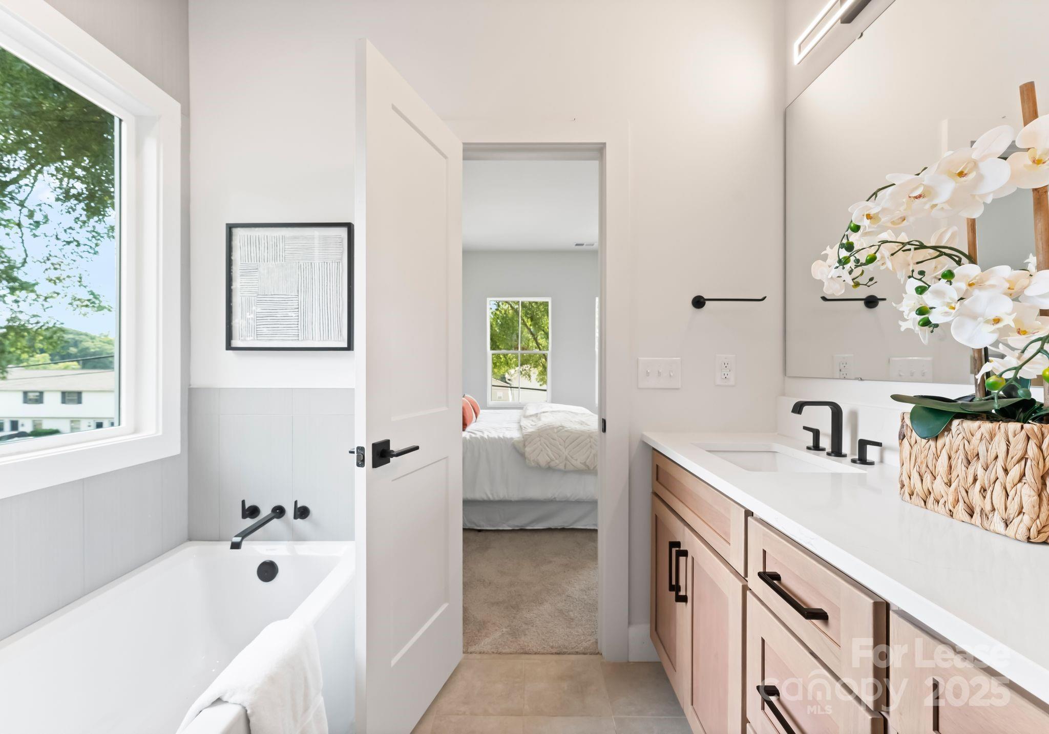 2413 Pruitt Street Charlotte, NC 28208 - Photo 19 of 35 a bathroom with a tub sink and mirror