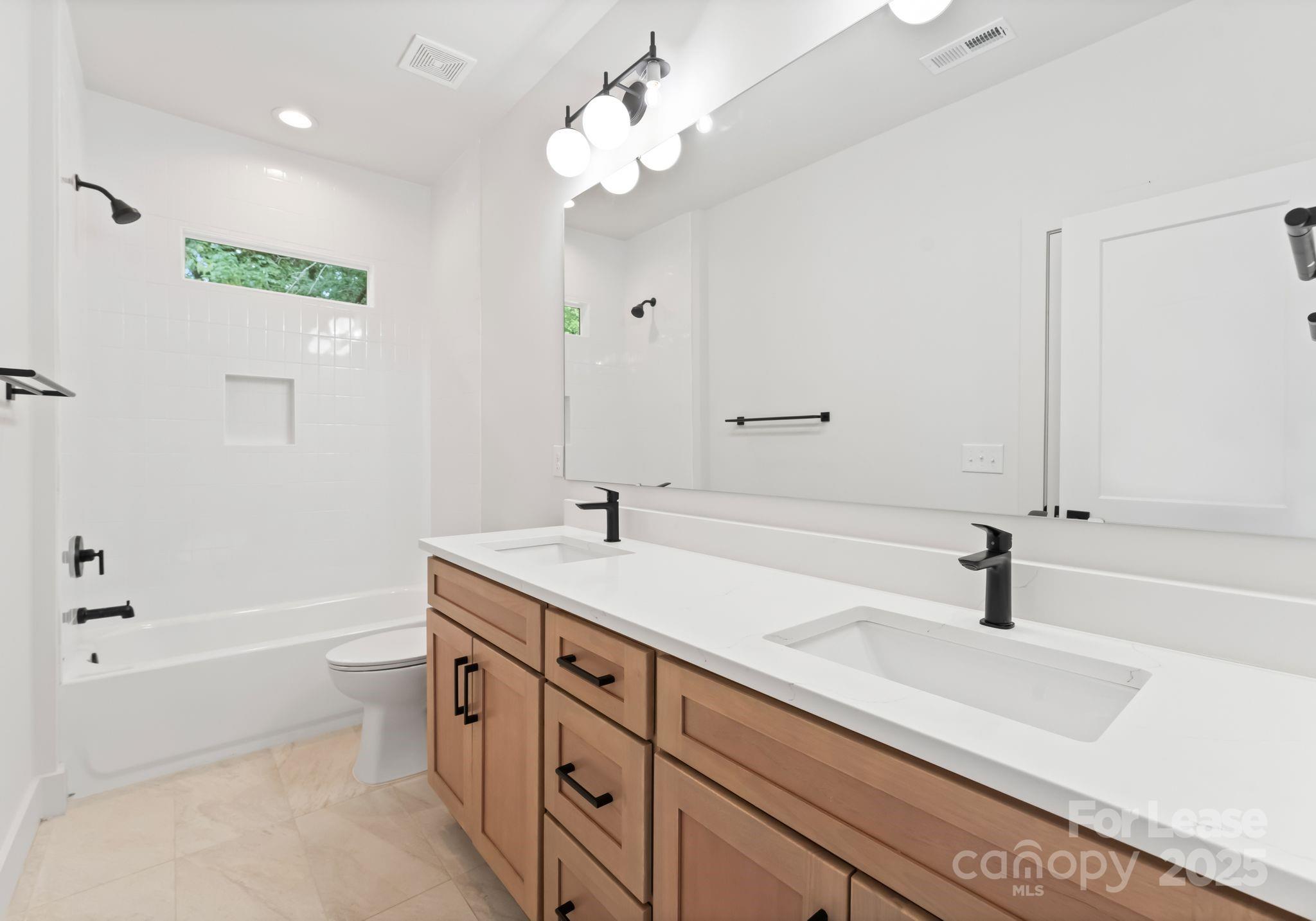 2413 Pruitt Street Charlotte, NC 28208 - Photo 21 of 35 a bathroom with a sink a toilet and a bathtub