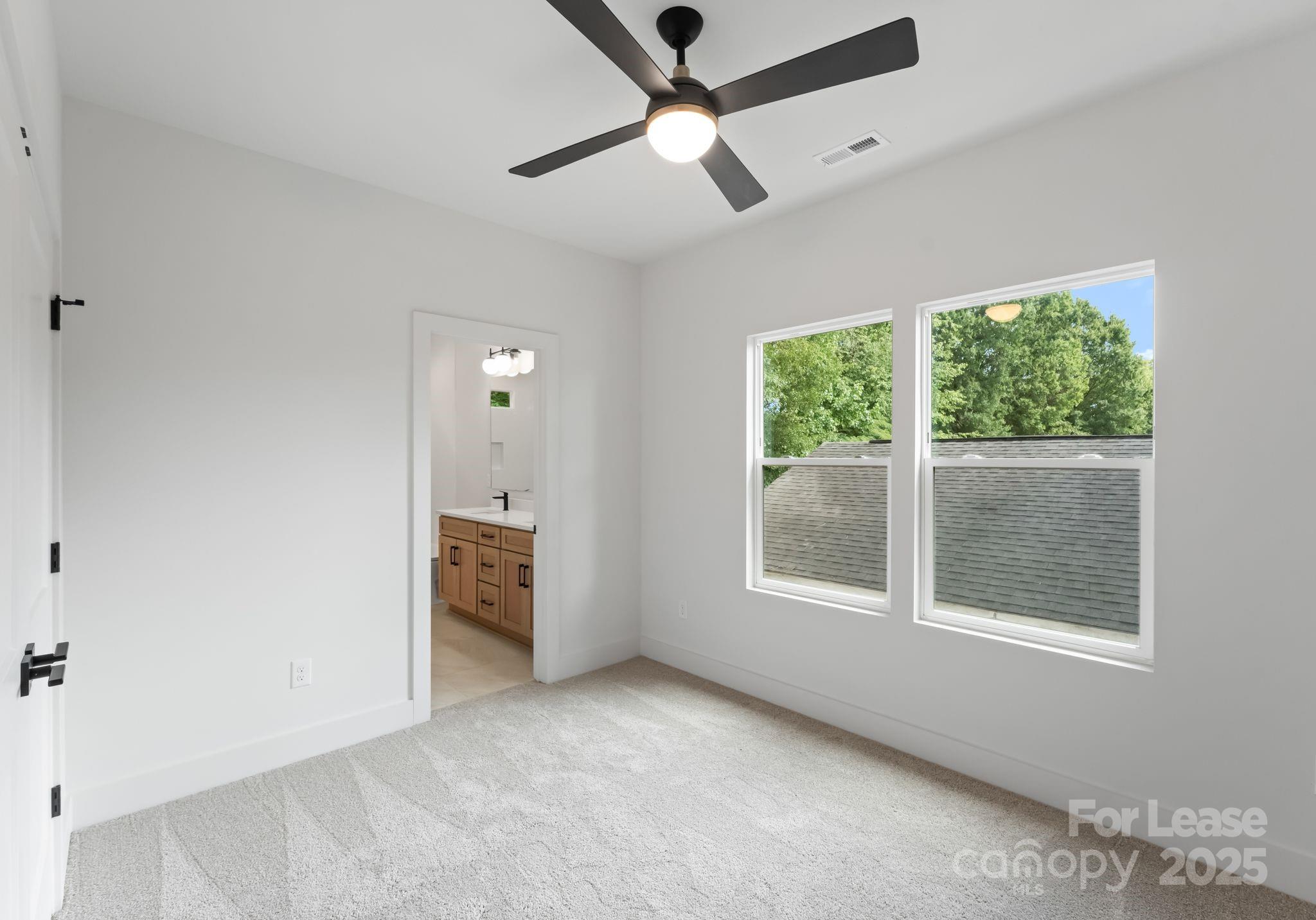 2413 Pruitt Street Charlotte, NC 28208 - Photo 22 of 35 a view of an empty room with a window and kitchen view