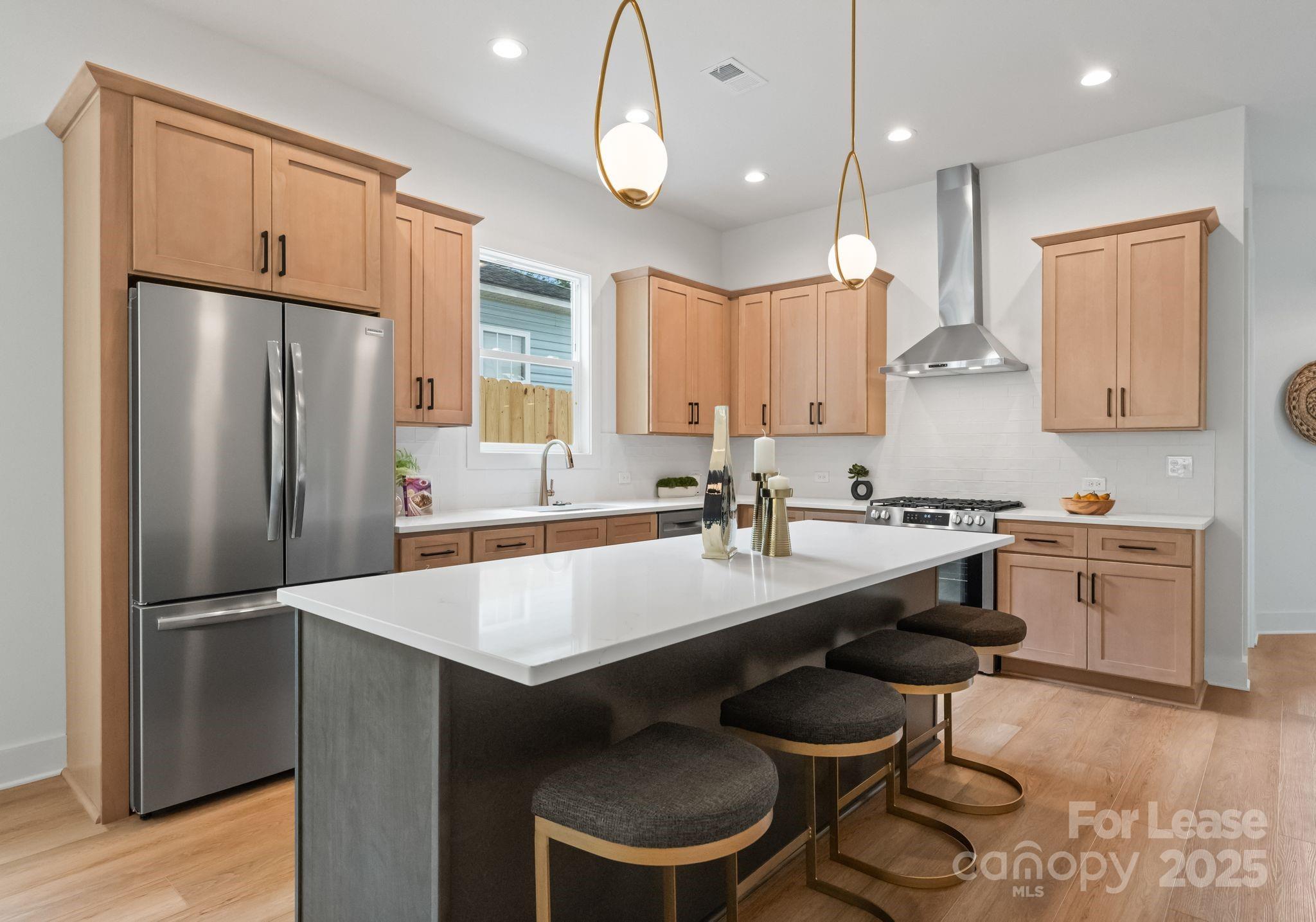 2413 Pruitt Street Charlotte, NC 28208 - Photo 25 of 35 a kitchen with granite countertop a sink stove and refrigerator