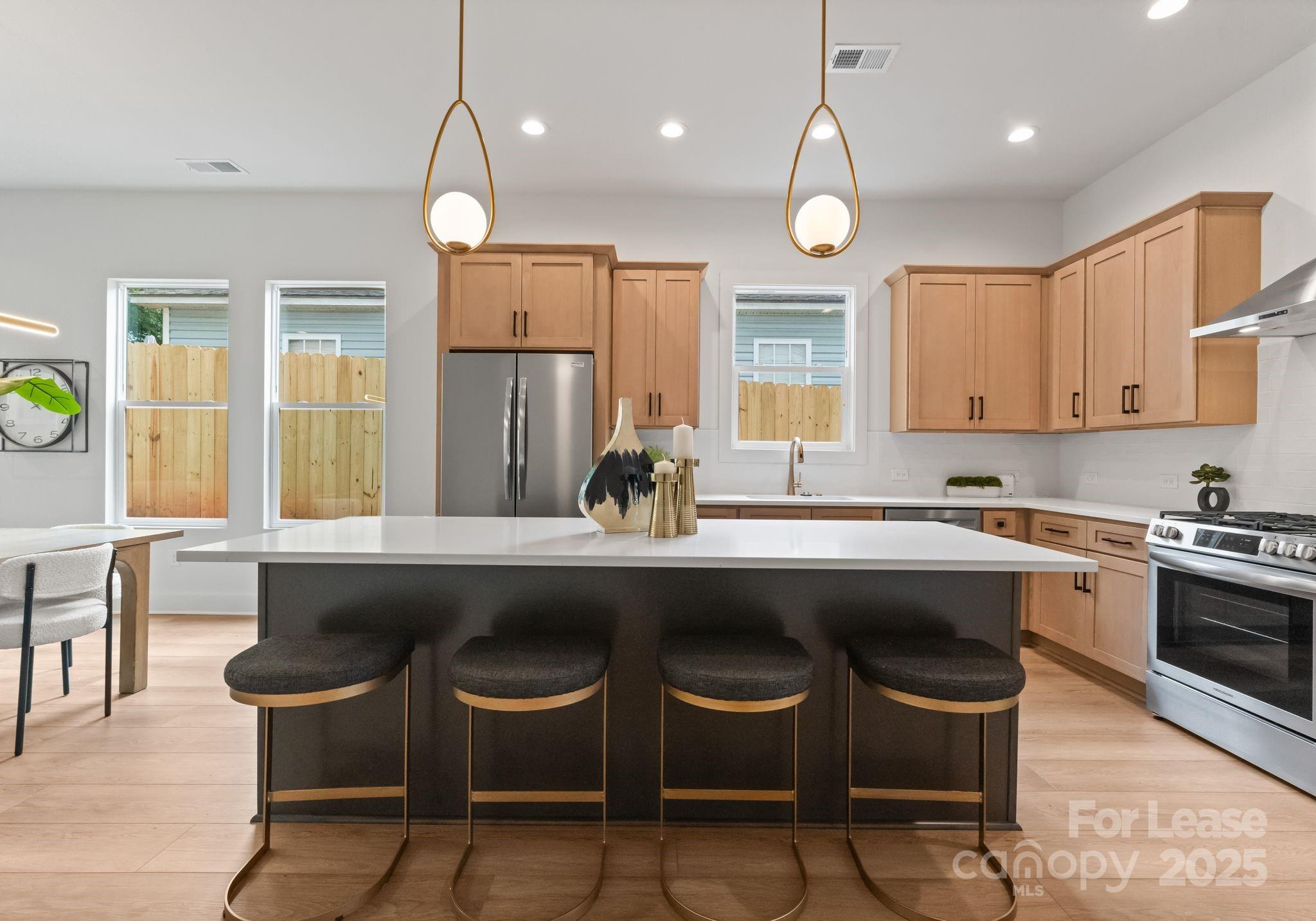 2413 Pruitt Street Charlotte, NC 28208 - Photo 26 of 35 a kitchen with a table chairs sink and cabinets