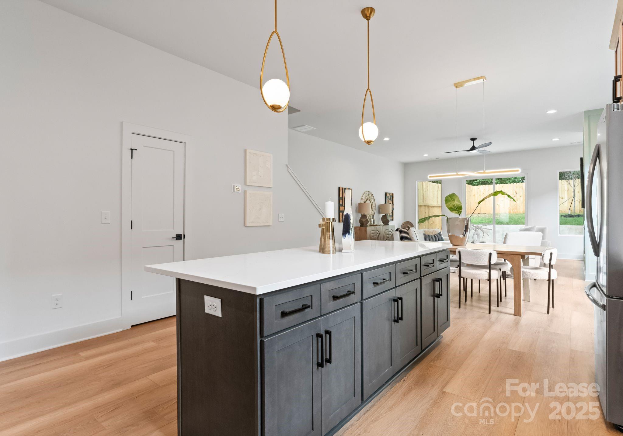 2413 Pruitt Street Charlotte, NC 28208 - Photo 28 of 35 a kitchen with center island table and chairs