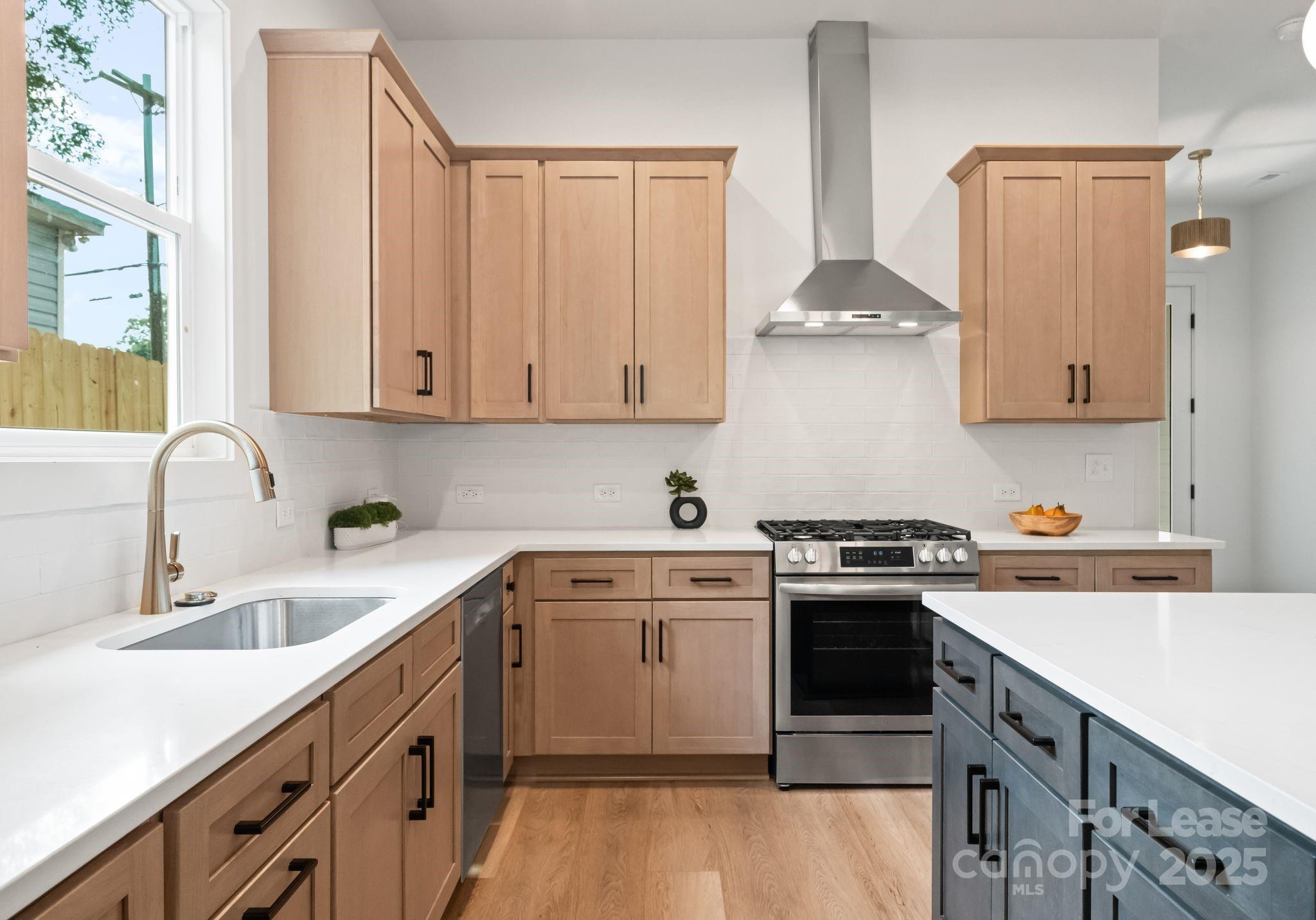 2413 Pruitt Street Charlotte, NC 28208 - Photo 29 of 35 a kitchen with stainless steel appliances granite countertop a sink stove and cabinets