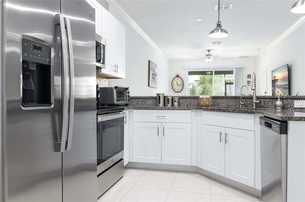 6736 Ripple Pond Loop Zephyrhills, FL 33541 - Photo 14 of 40 a kitchen with cabinets and stainless steel appliances